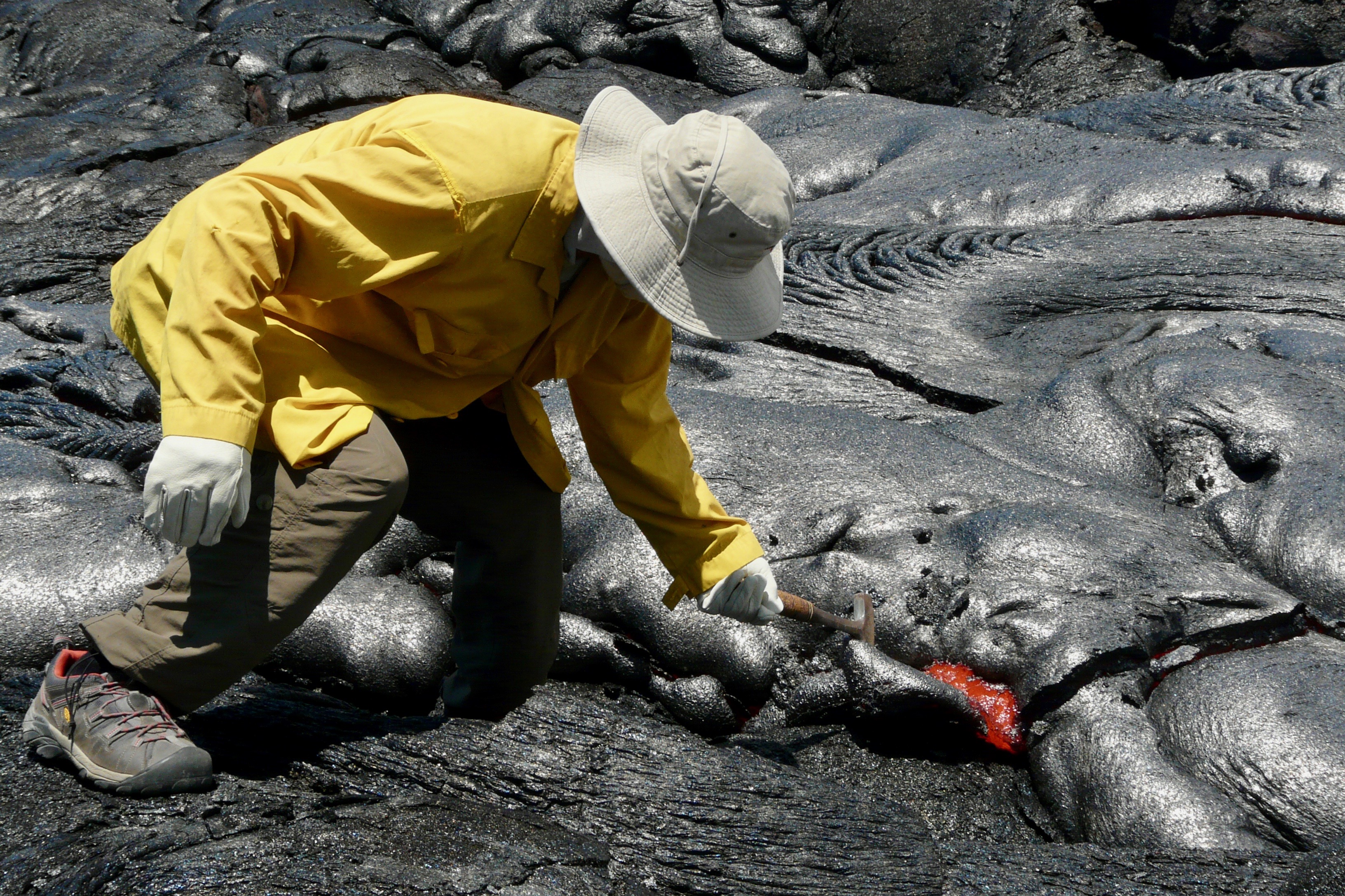 Field camp participants examining volcanic rock samples on Hawaii's Big Island