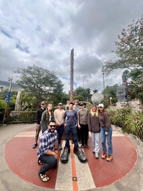 Field camp participants examining volcanic ash deposits in Ecuador