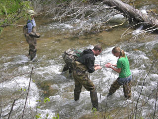 Geological engineering field camp students measuring slope stability parameters